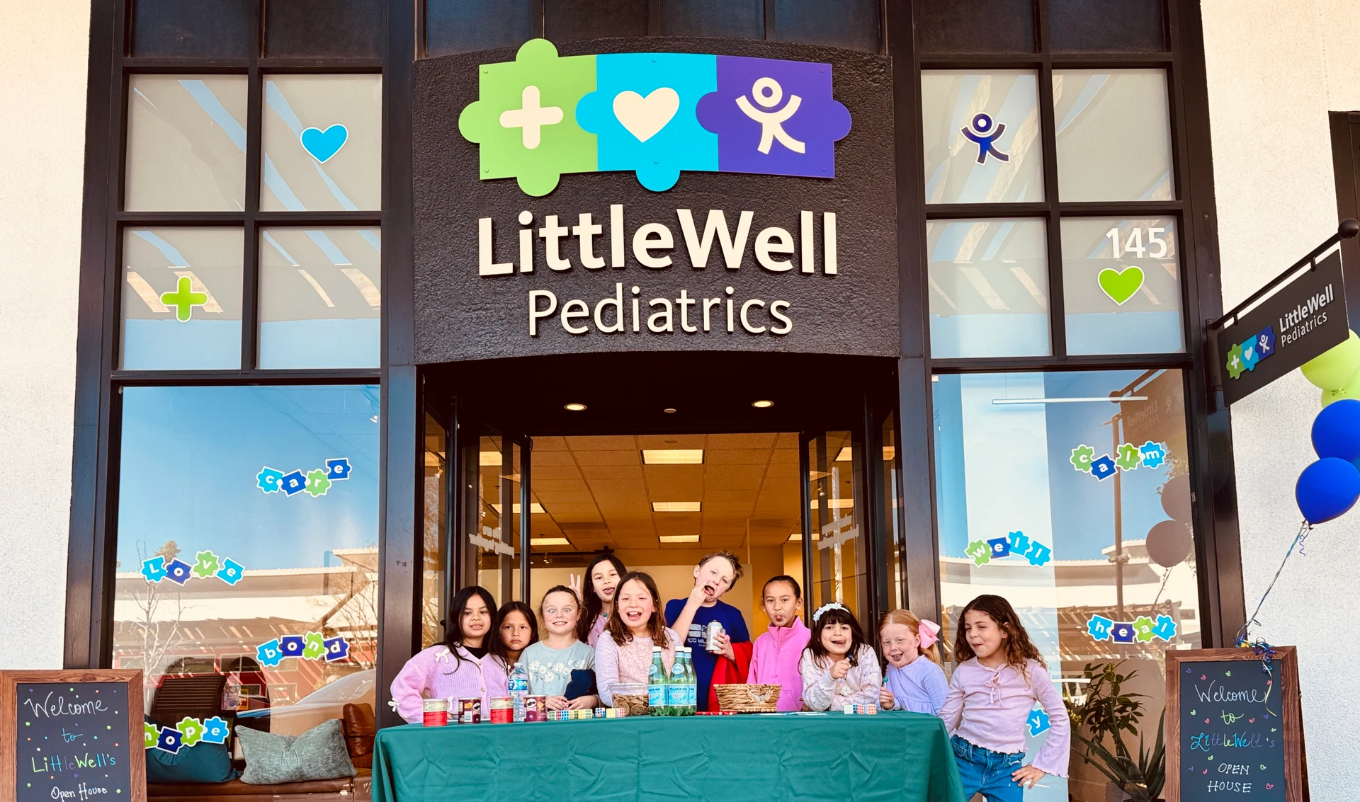 Children celebrating the LittleWell Pediatrics opening
